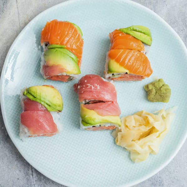 Elite Five Sushi & Grill's colorful sushi rolls with salmon, tuna, avocado, wasabi, and ginger.